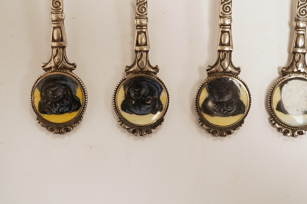 A matched set of six mainly George V silver/white metal and enamel teaspoons, with terminals decorated with dog's heads, 13.6cm. Condition - fair